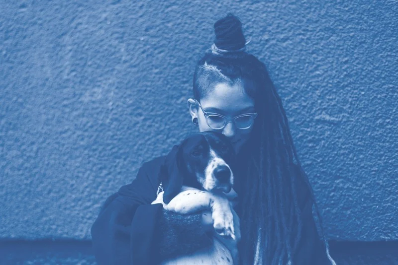 East Dogs founder cuddling a dog